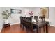 Formal dining room with hardwood floors, a large table, and seating for eight at 8510 Independence Way, Arvada, CO 80005