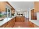 Bright kitchen with ample countertop space, wooden cabinets, and views into the adjacent living room at 8510 Independence Way, Arvada, CO 80005