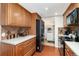 Functional kitchen with stainless steel appliances, tile backsplash, and access to a laundry room at 8510 Independence Way, Arvada, CO 80005
