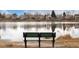 Scenic lake view featuring a bench, perfect for enjoying nature and relaxation at 8510 Independence Way, Arvada, CO 80005