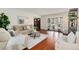 Bright living room featuring hardwood floors, comfortable seating, and a view of the front yard at 8510 Independence Way, Arvada, CO 80005