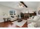 Inviting living room features vaulted ceiling, fireplace, neutral decor, and plenty of natural light at 8510 Independence Way, Arvada, CO 80005