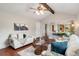 Comfortable living room showcasing natural light, hardwood floors, and views into the adjacent dining area at 8510 Independence Way, Arvada, CO 80005