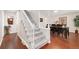 Elegant carpeted staircase leading to the second floor, adjacent to the dining area at 8510 Independence Way, Arvada, CO 80005
