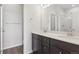 Bathroom featuring a dual sink vanity, and a glass-enclosed shower at 453 Interlocken Blvd # 103, Broomfield, CO 80021