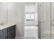 Modern bathroom featuring a glass shower, sleek vanity, and view to the bedroom at 453 Interlocken Blvd # 103, Broomfield, CO 80021