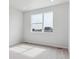 Bedroom with large windows offering neighborhood views and carpet floors at 453 Interlocken Blvd # 103, Broomfield, CO 80021