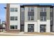 Contemporary townhome showcasing multiple exterior textures and colors with attached garages at 453 Interlocken Blvd # 103, Broomfield, CO 80021