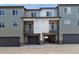 Modern townhome featuring multi-tone exteriors, individual garages, and private patios at 453 Interlocken Blvd # 103, Broomfield, CO 80021