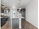 Modern kitchen with dark cabinets, quartz countertops and stainless steel appliances at 453 Interlocken Blvd # 103, Broomfield, CO 80021