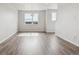 Bright living room with wood floors, recessed lighting, and a large window at 453 Interlocken Blvd # 103, Broomfield, CO 80021