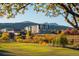 Building view from across a park with autumn colors at 12983 W Ida Ave # 401, Littleton, CO 80127