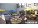 Outdoor patio with seating and umbrellas for relaxing at 12983 W Ida Ave # 401, Littleton, CO 80127