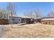 Charming backyard featuring a cozy deck, lovely covered patio, and well-maintained surroundings at 1842 S Fairfax St, Denver, CO 80222