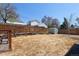 Spacious backyard featuring a tall wooden fence, storage shed, and raised garden beds at 1842 S Fairfax St, Denver, CO 80222