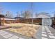 Backyard with a shed, garden beds, and a small wooden deck at 1842 S Fairfax St, Denver, CO 80222