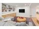 Finished basement with built-in shelving and cabinets, and a TV at 1842 S Fairfax St, Denver, CO 80222