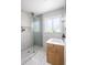 Modern bathroom with glass-enclosed shower, and modern fixtures, and hexagon tile floor at 1842 S Fairfax St, Denver, CO 80222