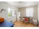 Bright bedroom featuring hardwood floors, desk with wallpaper accent wall, and lots of natural light at 1842 S Fairfax St, Denver, CO 80222