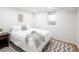 Simple white bedroom with gray and white decor and a chevron pattern area rug at 1842 S Fairfax St, Denver, CO 80222