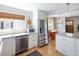 Modern kitchen featuring stainless steel appliances, white cabinetry, granite countertops and open dining area at 1842 S Fairfax St, Denver, CO 80222