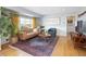 Comfortable living room with hardwood floors, a leather couch, and ample natural light at 1842 S Fairfax St, Denver, CO 80222