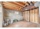 Unfinished basement with exposed ceiling, concrete walls, and space for customization at 3276 S Osceola St, Denver, CO 80236