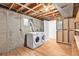 Unfinished basement with washer, dryer, exposed ceiling, and concrete walls, ready for customization at 3276 S Osceola St, Denver, CO 80236