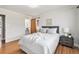 Bedroom featuring hardwood floors, ensuite bathroom and natural light at 3276 S Osceola St, Denver, CO 80236