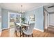 Dining area featuring hardwood floors, a chandelier, and access to the backyard at 3276 S Osceola St, Denver, CO 80236