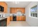 Bright kitchen with oak cabinetry, laminate countertops, and ample natural light at 3276 S Osceola St, Denver, CO 80236