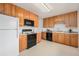 Well-lit kitchen featuring oak cabinets and plenty of counter space at 3276 S Osceola St, Denver, CO 80236