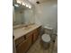 Bathroom with a single sink, wood cabinets, and toilet, offering functionality at 1270 N Marion St # 103, Denver, CO 80218