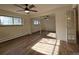Bright bedroom featuring wood floors, ceiling fan, sliding mirror closet doors and a window at 1270 N Marion St # 103, Denver, CO 80218