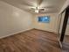 Bedroom with hardwood floor, window, ceiling fan, and mirrored closet at 1270 N Marion St # 103, Denver, CO 80218