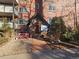 Charming brick condo building entrance with inviting landscape and a cozy bench at 1270 N Marion St # 103, Denver, CO 80218