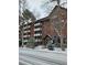 Attractive multi-story brick building with balconies and mature trees at 1270 N Marion St # 103, Denver, CO 80218
