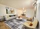 Bright living room with a modern sofa, stylish rug, and contemporary art at 1270 N Marion St # 103, Denver, CO 80218