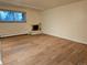 Spacious living room offers wood floors, brick fireplace, and natural light at 1270 N Marion St # 103, Denver, CO 80218