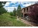 Landscaped backyard with a sloped lawn and rock garden at 3512 Cascina Pl # A, Highlands Ranch, CO 80126