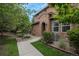 Stone exterior of townhome with landscaped walkway at 3512 Cascina Pl # A, Highlands Ranch, CO 80126