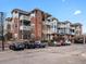Attractive condominiums with brick and blue siding, white balconies and well-maintained parking area at 2428 W 82Nd Pl # 2D, Westminster, CO 80031