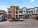 Attractive condominiums with brick and blue siding, white balconies, and well-maintained parking area at 2428 W 82Nd Pl # 2D, Westminster, CO 80031