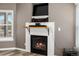 Close-up of the fireplace with a TV and mantle providing heat and entertainment at 2428 W 82Nd Pl # 2D, Westminster, CO 80031