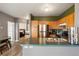 Bright kitchen with stainless steel refrigerator, wood cabinets, and a view to an adjacent bedroom at 2428 W 82Nd Pl # 2D, Westminster, CO 80031
