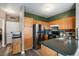 Functional kitchen with stainless steel appliances, wood cabinets, and ample counter space at 2428 W 82Nd Pl # 2D, Westminster, CO 80031