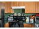 Cozy kitchen featuring wood cabinets, dark countertops, and a black range at 2428 W 82Nd Pl # 2D, Westminster, CO 80031
