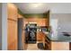 Well-lit kitchen featuring stainless steel appliances and wood cabinets, ideal for cooking and storage at 2428 W 82Nd Pl # 2D, Westminster, CO 80031