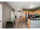 Open layout with stainless steel appliances, wood cabinets, and dining area at 2428 W 82Nd Pl # 2D, Westminster, CO 80031