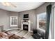 Charming living room featuring a fireplace, a TV and ample natural light from nearby windows at 2428 W 82Nd Pl # 2D, Westminster, CO 80031
